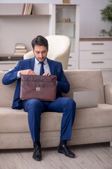 Young male employee working from home during pandemic