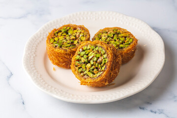 Traditional Turkish desserts; Kadaif stuffed with pistachios. Turkish name; Kadayif dolmasi or dolma kadayif. Halep sarma, halep sarmasi.