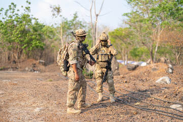 Team of U.S. Army marine corps soldier military war with gun weapon participating and preparing to attack the enemy in Thailand during exercise Cobra Gold training in battle. Combat force.