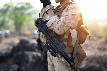 Team of U.S. Army marine corps soldier military war with gun weapon participating and preparing to attack the enemy in Thailand during exercise Cobra Gold training in battle. Combat force. © tampatra