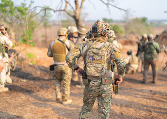 Team of U.S. Army marine corps soldier military war with gun weapon participating and preparing to attack the enemy in Thailand during exercise Cobra Gold training in battle. Combat force.