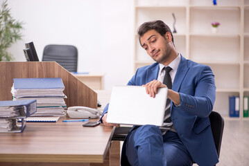 Young male employee working in the office