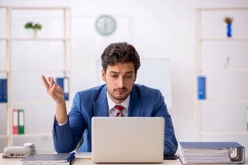 Young male employee working in the office