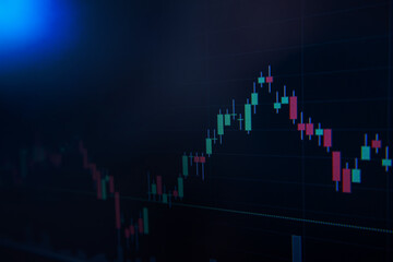 Screen of laptop of stock market candlestick chart on blue background. Stock market trends concept.