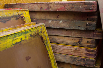 Wooden used screen printing frames stacked