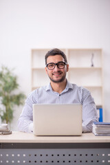 Young male employee working in the office