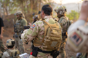 Team of U.S. Army marine corps soldier military war with gun weapon participating and preparing to attack the enemy in Thailand during exercise Cobra Gold training in battle. Combat force.