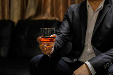 businessmen holding a glass of whiskey