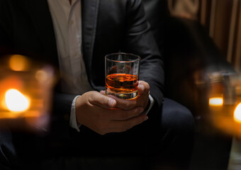 businessmen holding a glass of whiskey