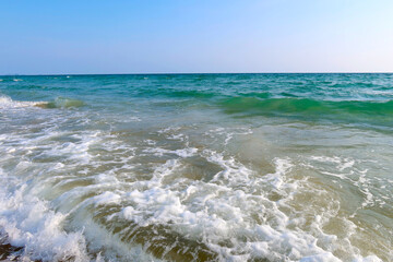 Beach with wave and blue sea water background