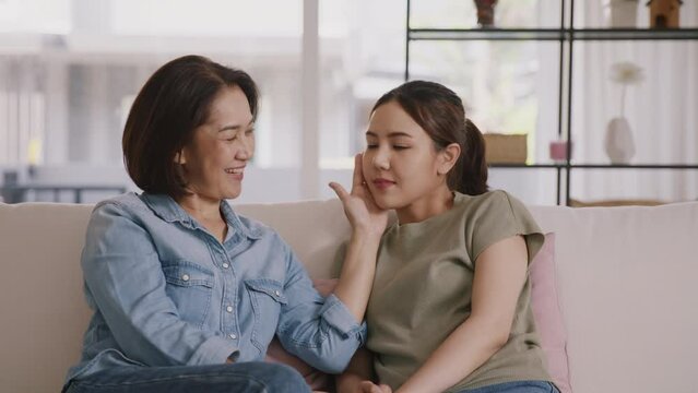 Middle aged asia people old mom love care trust comfort help young teen talk crying stress relief at home. Mum as friend listen adult child woman feel pain sad worry of broken heart life crisis issues