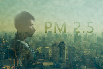 Asian man wear a mask with fog or haze combined with smoke and other atmospheric pollutants in the city from PM 2.5 dust.Cityscape with word of PM 2.5 and air pollution. PM 2.5 concept.