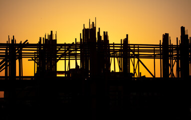 Silhouette building construction at sunset.