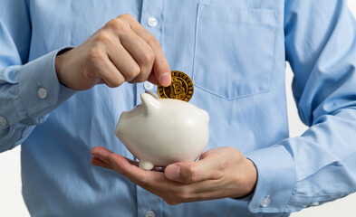 Bitcoin coin into piggy bank