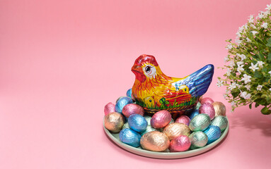 Paschal, Easter kids gift. Chocolate hen, little chickens with colorful bright sweet eggs wrapped...