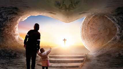 Easter and Good Friday concept, Mom and child standing with empty tomb of Jesus Christ at cross on...