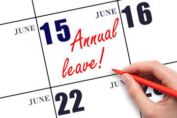 Hand writing the text ANNUAL LEAVE and drawing the sun on the calendar date June 15