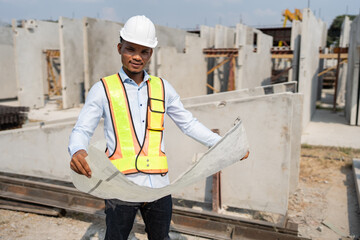 Portrait Asia man engineer hard working with paper work at precast cement factory	