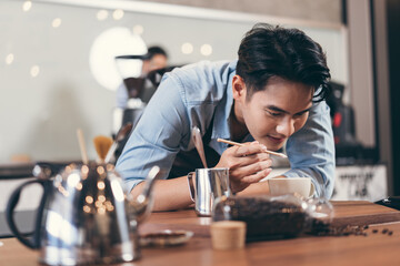 Happy barista Asia man make coffee  at coffee shop	