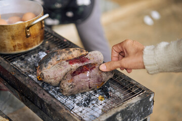 cooking sweet potatoes on a charcoal grill