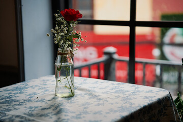 flowers in a vase on table in cafe
