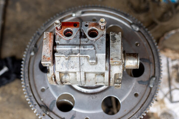 Checking and repairing air compressor of car at workshop