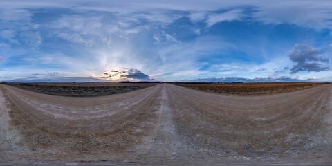 evening 360 hdri panorama on gravel road with clouds on blue sky before sunset in equirectangular spherical seamless projection, use as sky replacement in drone panoramas, game development as sky dome