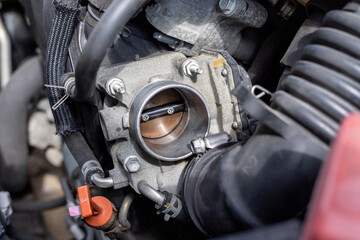 Cleaning car engine throttle body closeup with selective focus