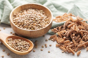 Green lentil fusilli pasta on a gray concrete background.