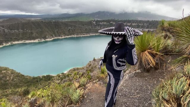 Woman dressed as a Mexican catrina skull posing on a mountain with lightning in the clouds.