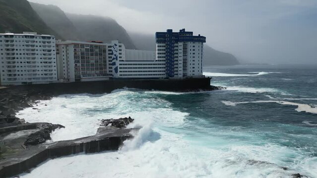 Mesa del Mar natural sea water pools with strong waves in Tenerife Canary islands Spain, Aerial dolly right shot