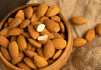 Raw Organic almonds on rustic wood table.Top view