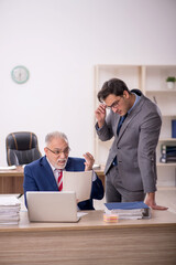 Two male colleagues sitting in the office