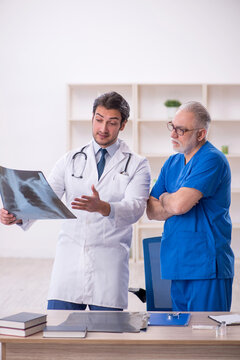 Two Male Doctors Radiologists Working In The Clinic