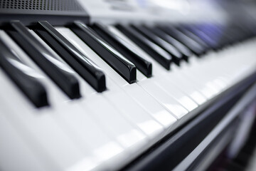 Keys of a synthesizer or grand piano closeup. Monochrome music concept background.