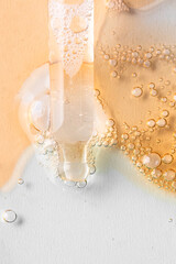 Close up of pipette with with bubbles drops and different cosmetic swatch of oil, collagen, enzyme,...
