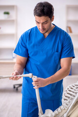 Young male doctor and skeleton patient at the hospital