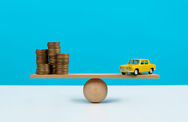 Seesaw with coins and car model