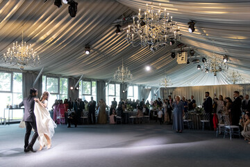 Dance of lovely couple. Wedding. Tent