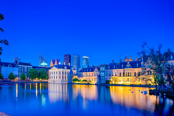 Naklejka premium Binnenhof Palace of Parliament in The Hague in The Netherlands at Blue Hour.Skyscrapers Skyline On The Background.