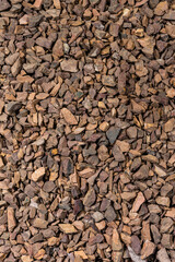Closeup Image of Background Made of Pile of Colorful Brown, Yellow and Red Crushed Stone