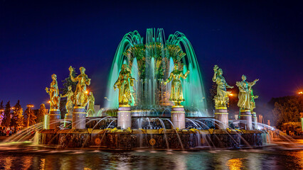 Moscow, Russia - Central fountain in VDNKh exhibition centre built in 1954 illuminated at night