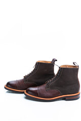 Footwear Ideas. Dark Brown Grain Brogue Derby Boots Made of Calf Leather with Rubber Sole Placed in Line Together Over White Background.