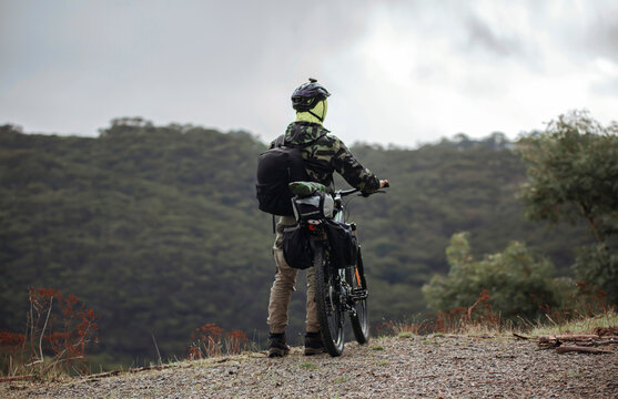 Man with a mountain bike, in camouflage clothes, bike packing on top of a hill in Adelaide, South Australia