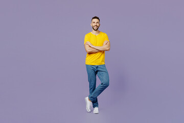 Fototapeta na wymiar Full body young smiling cheerful cool fun caucasian man wear yellow t-shirt hold hands crossed folded look camera isolated on plain pastel light purple background studio portrait. Lifestyle concept.