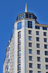 Fragment of the facade of a multi-storey residential building on a spring day