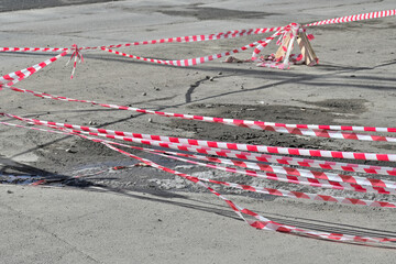 Safety tape at the repair site on a spring day