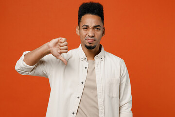 Young displeased dissatisfied man of African American ethnicity wear light shirt casual clothes...