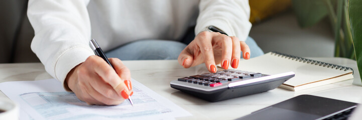 Business woman calculating balance prepare tax reduction income, cost budget expenses for pay money form personal Individual Income Tax Return