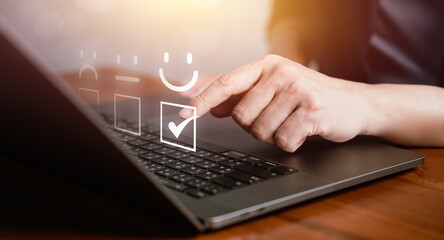 Man using a computer to give feedback and satisfaction rating, representing positive experience